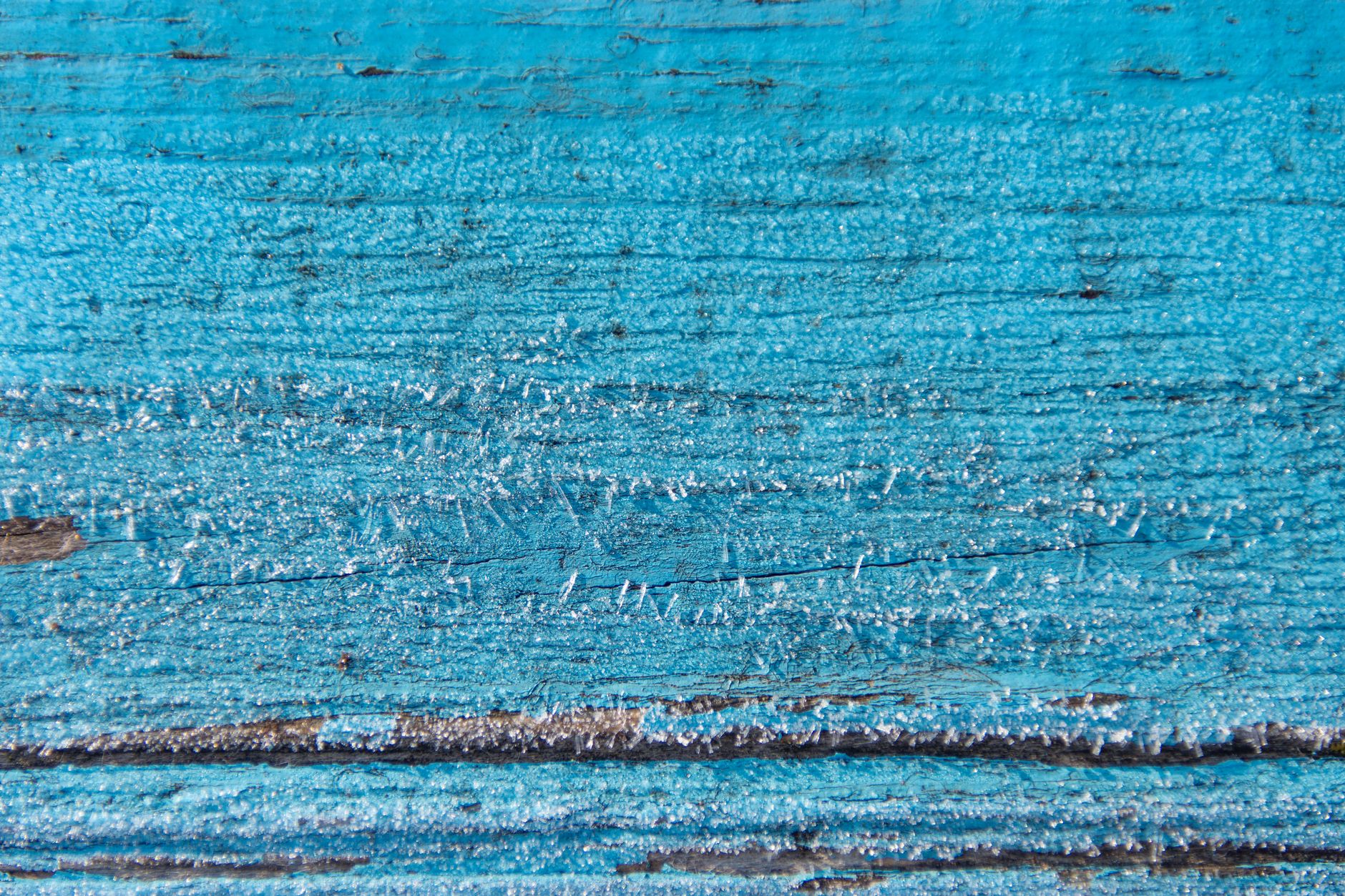 a thin line of white powder dusted along a wooden baseboard