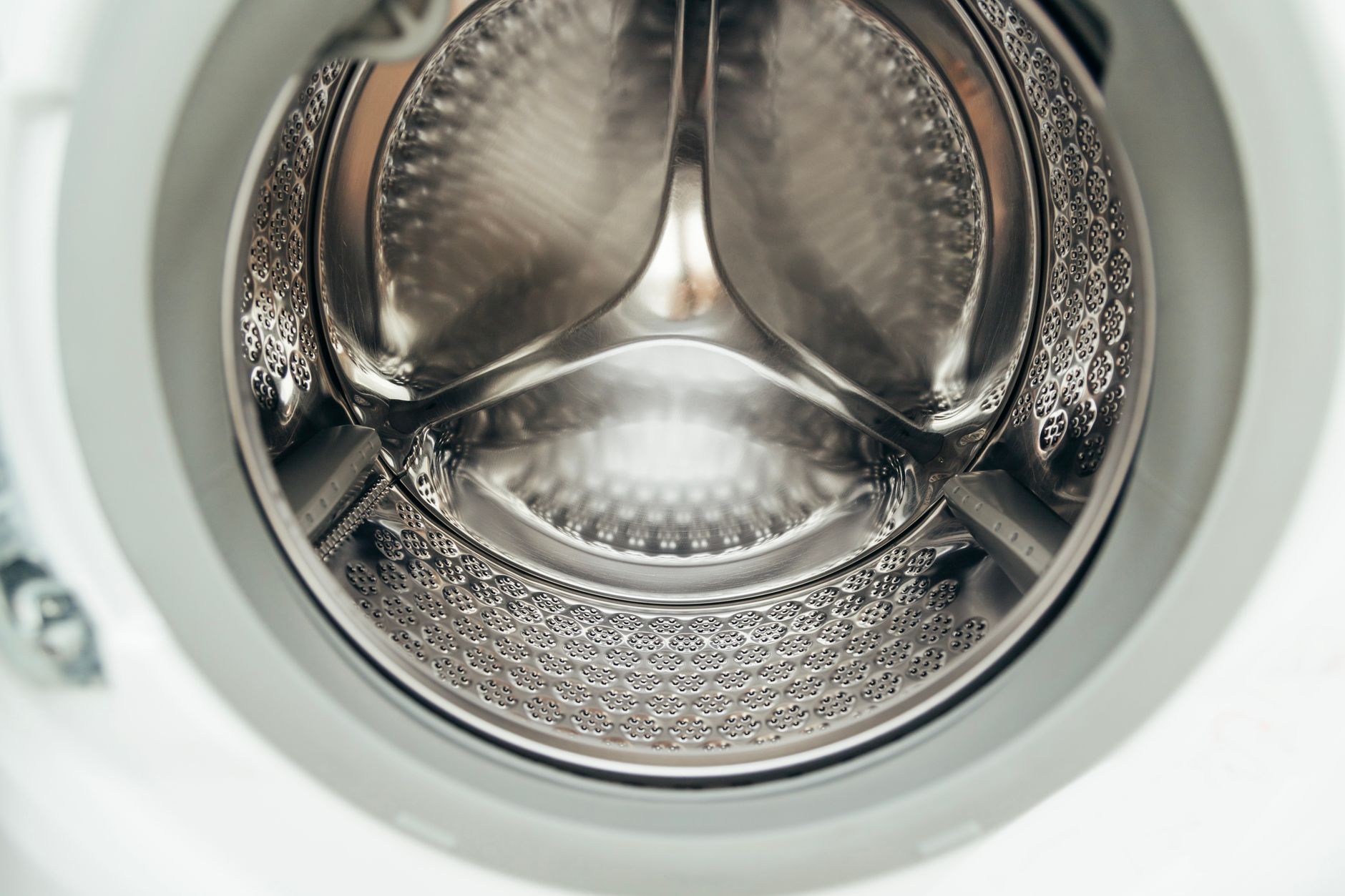 washing machine drum with a mesh laundry bag inside