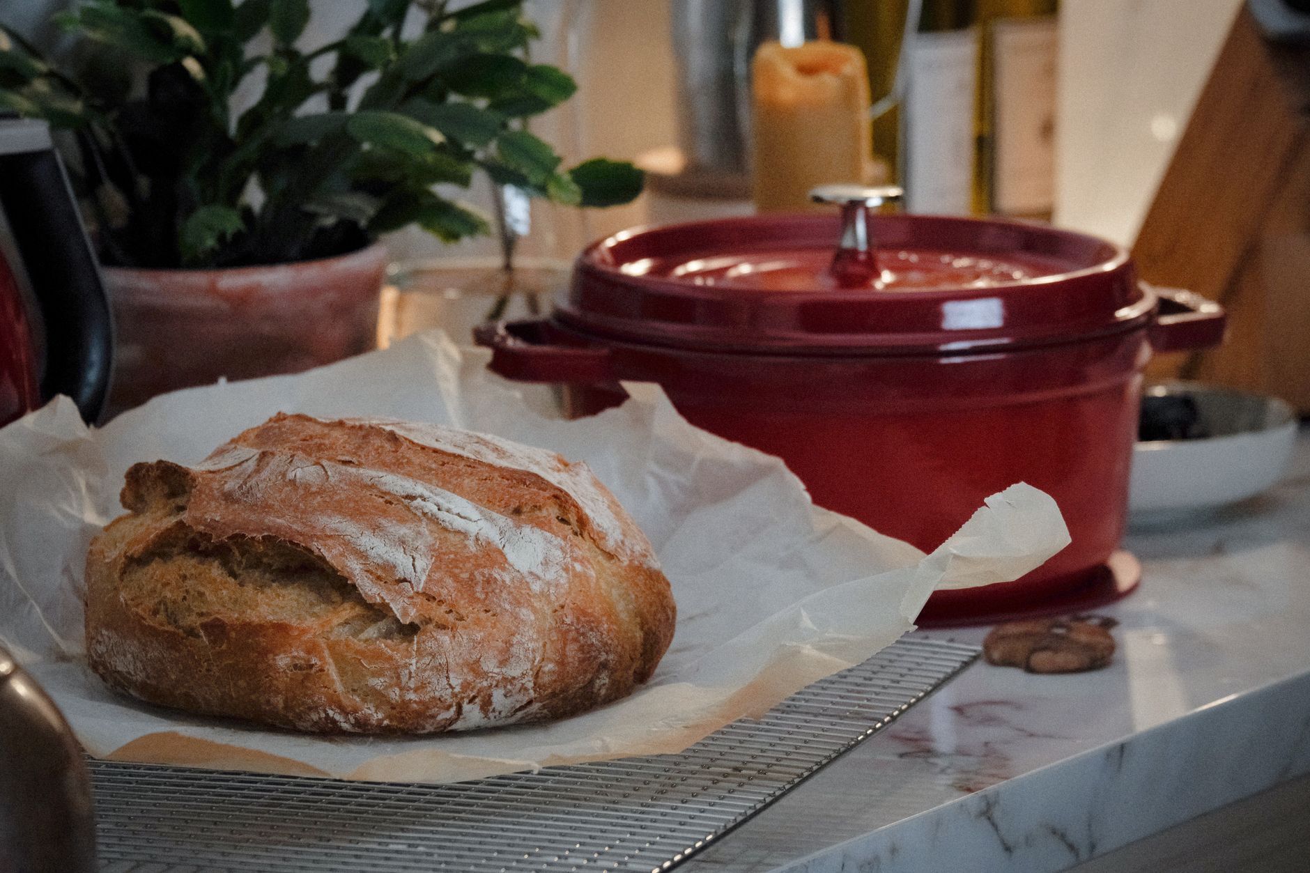 an enameled cast iron dutch oven filled with red tomato sauce sitting on a stovetop